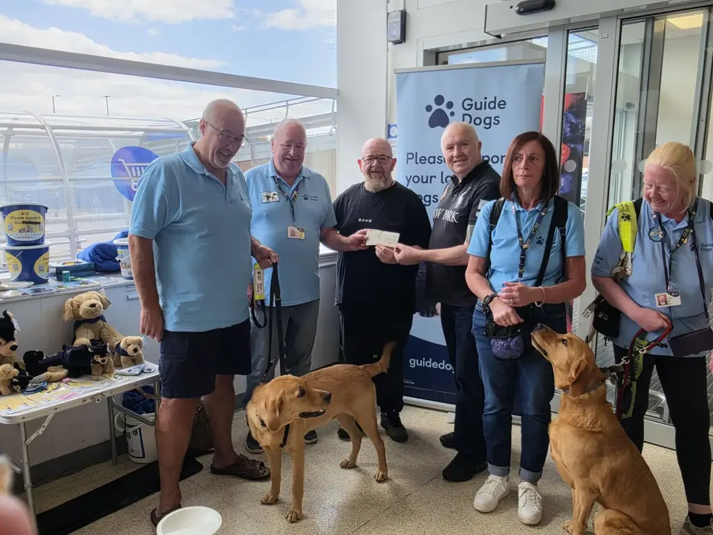 Patrick Breem and Matt Wynne, Worshipful Master of Abbey Lodge No. 432, to present the donation to representatives of Guide Dogs for the Blind Nuneaton Branch